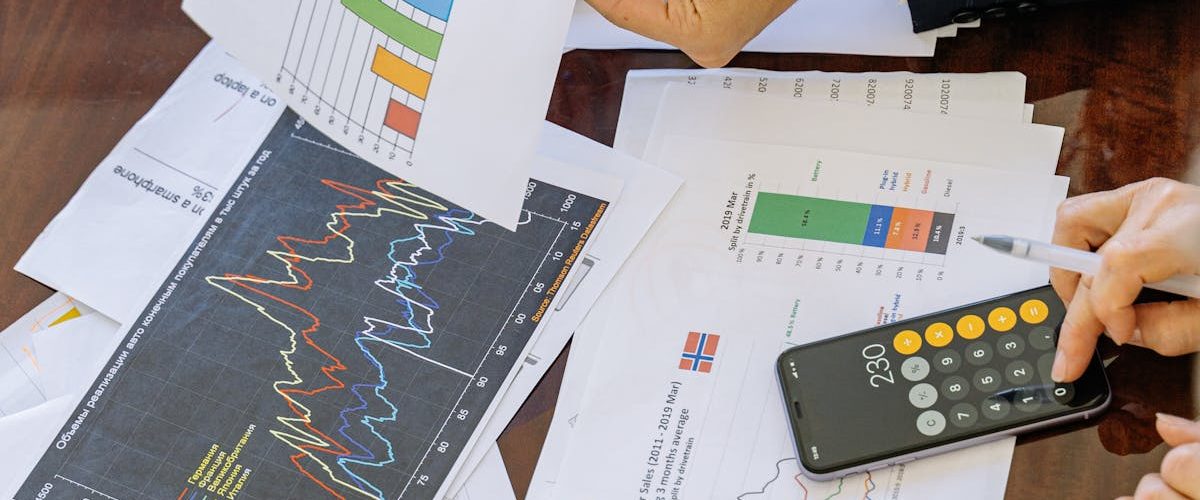 Business professionals analyzing financial charts and graphs during a meeting.